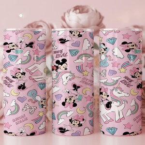 May include: Three pink tumblers with a repeating pattern of cartoon characters, rainbows, stars, and diamonds. The tumblers feature Mickey and Minnie Mouse, unicorns, and the phrases "100% Real" and "Unicorn Dreams."