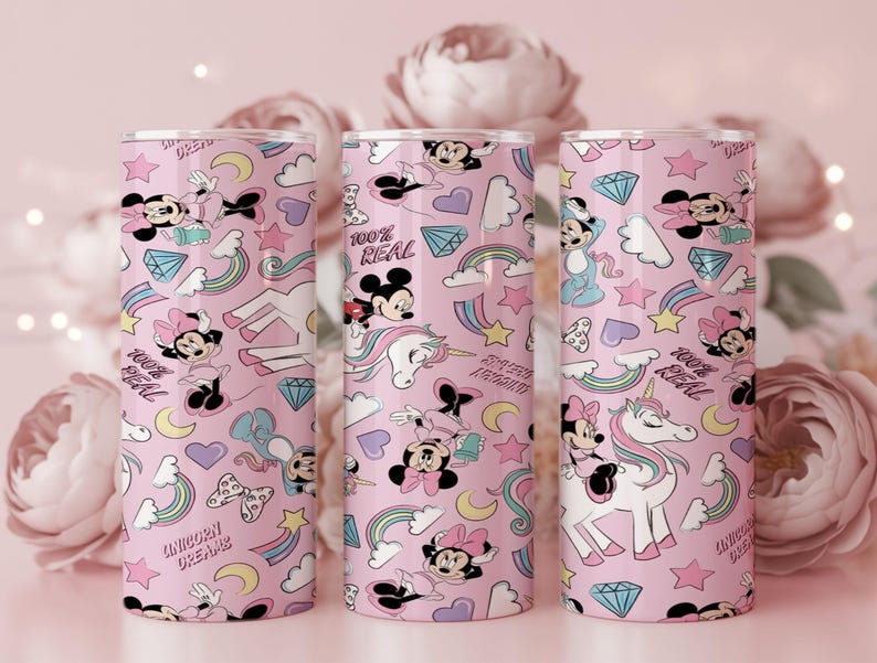 May include: Three pink tumblers with a repeating pattern of cartoon characters, rainbows, stars, and diamonds. The tumblers feature Mickey and Minnie Mouse, unicorns, and the phrases "100% Real" and "Unicorn Dreams."