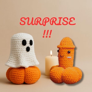May include: A Halloween-themed image featuring two crocheted figures and a lit candle. One figure is a white ghost atop an orange pumpkin. The other is an orange figure with a face and a hat. The word "SURPRISE" is written in red.