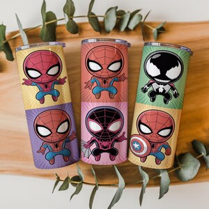 May include: Six colorful insulated tumblers featuring cartoon Spider-Man characters. Each tumbler has a different design, including Spider-Man, Venom, and Spider-Man with the Captain America shield. The tumblers are cylindrical and have a metallic finish.