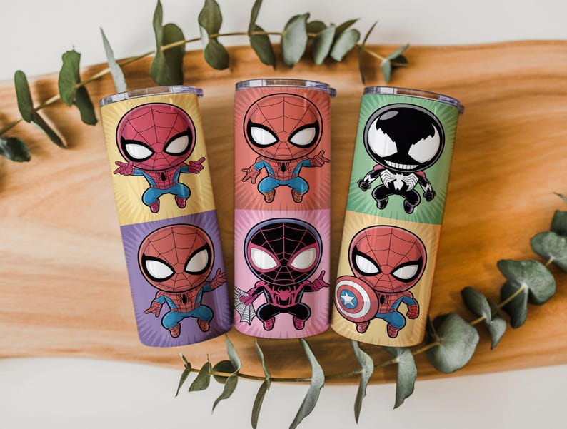 May include: Six colorful insulated tumblers featuring cartoon Spider-Man characters. Each tumbler has a different design, including Spider-Man, Venom, and Spider-Man with the Captain America shield. The tumblers are cylindrical and have a metallic finish.