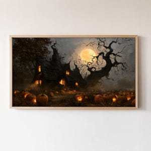 May include: A rectangular framed wall art print depicting a dark, atmospheric scene of a house with glowing windows at night. A large, gnarled, leafless tree stands beside the house under a full moon, with numerous lit jack-o'-lanterns in the foreground.