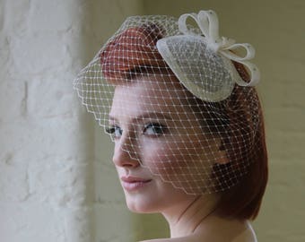 Ivory bridal bird cage veil bow fascinator. Cocktail ht for wedding with full vintage style veiling. Hand made in Uk