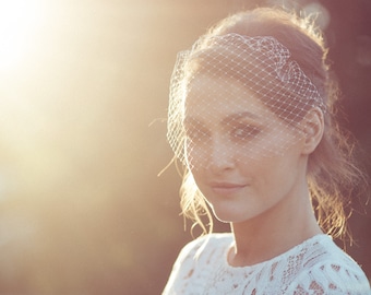 Bird cage veil on narrow hair band for a vintage wedding look, worn on its own or to style with other hair accessories.