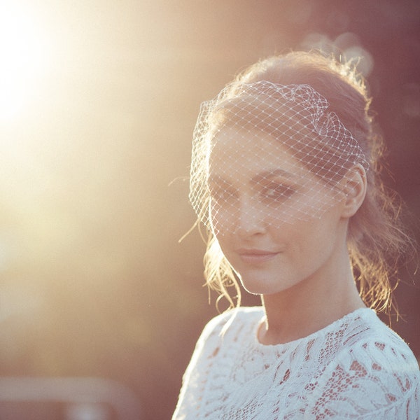 Bird cage veil on narrow hair band for a vintage wedding look, worn on its own or to style with other hair accessories.