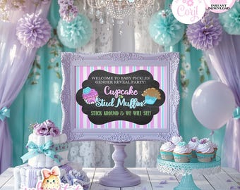 May include: A gender reveal party scene with a sign that reads "Cupcake or Stud Muffin?" in a decorative frame. The scene includes cupcakes, a cake, balloons, and floral decorations in pastel colors. The text "Welcome to Baby Pickles Gender Reveal Party!" is also visible.