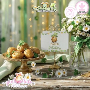 May include: A festive St. Patrick's Day arrangement with baked potatoes on a gold stand, a sign with a potato character, and a vase of daisies. The sign says "Baked Potatoes". The scene is decorated with shamrocks and gold coins.