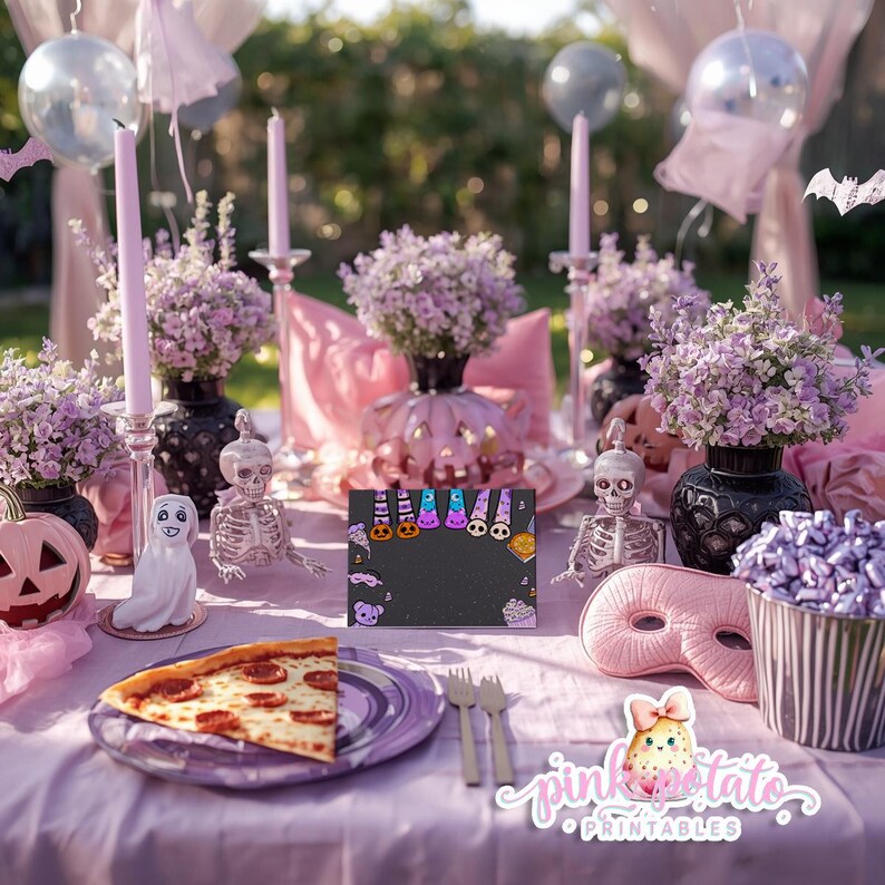 May include: A Halloween table setting with pink and purple decorations. Features a slice of pizza, a black chalkboard sign with Halloween graphics, floral arrangements, and decorative skeletons. The table is set with plates, forks, and a mask.