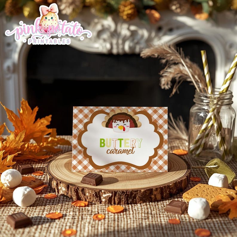 May include: A Thanksgiving-themed card with a turkey illustration and the words "Buttery Caramel" on a wooden slice. The card has a brown and white checkered pattern. The image includes chocolates, fall leaves, and a jar with straws.