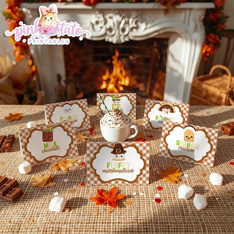 May include: A cozy scene featuring a mug of whipped cream-topped hot chocolate surrounded by ingredient cards for s'mores. The cards are labeled with text like "Fluffy Marshmallows" and "Graham Crackers" on a brown and white checkered background. Autumn leaves and chocolate bars complete the setting.