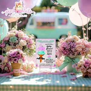 May include: A baby shower invitation featuring an ice cream cone design with pink and mint green colors. The invitation is surrounded by bouquets of pink and purple flowers, balloons, and a vintage ice cream truck in the background.