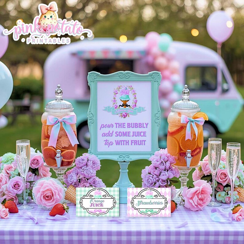 May include: A party scene with a pastel pink and teal food truck. Two glass beverage dispensers filled with fruit and a sign that reads "pour the bubbly add some juice top with fruit". The table is decorated with flowers.