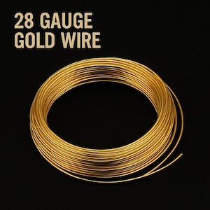 May include: A coil of 28 gauge gold wire against a black background. The wire is tightly wound, with a bright, metallic sheen. The text "28 GAUGE GOLD WIRE" is displayed in a gold color at the top of the image.