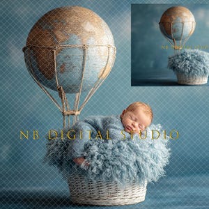 May include: A newborn baby in a blue outfit sleeps peacefully in a fluffy blue nest inside a white wicker basket. Above, a globe-shaped hot air balloon with a brown and blue design hangs from a woven basket. The background is a blue sky.