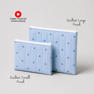 May include: Two light blue quilted pouches with a darker blue polka dot pattern and white zippers. The smaller pouch is labeled Quilted Small Pouch and the larger one is labeled Quilted Large Pouch, with a red play button icon for Video Tutorial+Instructions.