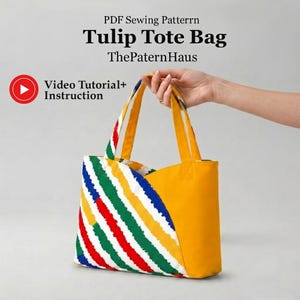 May include: A PDF sewing pattern for a Tulip Tote Bag by ThePaternHaus, featuring a video tutorial and instructions. The tote bag has a solid yellow side and a side with diagonal stripes in green, red, yellow, and blue, with two yellow handles.