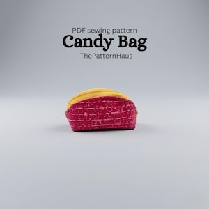 May include: A red and yellow Candy Bag, a PDF sewing pattern from ThePatternHaus. The bag is a small, rectangular shape with a yellow top and a red body with a white dotted pattern. The text "Candy Bag" is in large, bold letters.