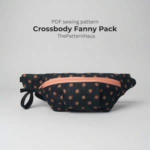 May include: Black crossbody fanny pack with brown polka dots and a peach-colored zipper. The text "Crossbody Fanny Pack" and "ThePatternHaus" are visible. The fanny pack has a black strap.