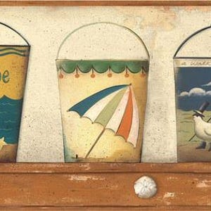 May include: Three decorative beach-themed buckets with arched handles. The first bucket has the word "Seaside" and a beach ball. The second bucket has a beach umbrella. The third bucket has a bird with a top hat and flags.