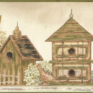 May include: A decorative border featuring two rustic birdhouses with green and brown accents. A small bird stands near the birdhouses, and white flowers and foliage are also present. The background is a light beige color.