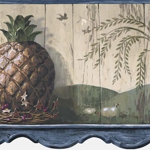 May include: A decorative wallpaper border featuring a large pineapple with a green leafy top. The pineapple sits on a shelf with a small nest, stars, and berries. The background has a painted landscape with sheep and a weeping willow.