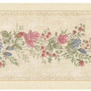 May include: Floral wallpaper border featuring pink and blue roses, small red flowers, and green leaves on a beige background. The design includes a decorative wavy line at the top and bottom.