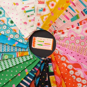 May include: A collection of colorful fabric swatches arranged in a circular pattern. The fabrics feature various patterns, including flowers, cherries, and geometric shapes. A central card reads "Trinketry by Melody Miller."