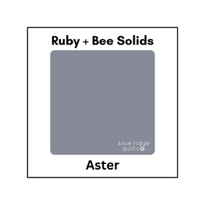 May include: A solid color fabric swatch in a light blue shade called "Aster" from the Ruby + Bee Solids collection by Blue Ridge Quilt Co.