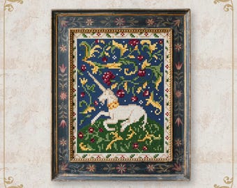 May include: Framed cross-stitch artwork depicting a white unicorn in a floral setting. The background is a deep blue with red berries and yellow accents. The frame is dark blue with ornate detailing and the text "NobleLadyPupsik".