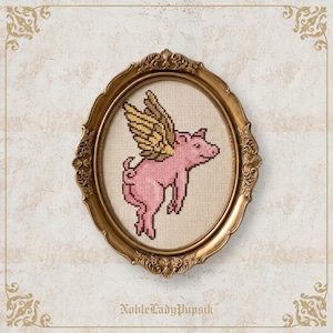 May include: A cross-stitch embroidery of a pink pig with gold wings, framed in an ornate oval gold frame. The pig is depicted in profile, facing right, with a curled tail. The text NobleLadyPupsik is printed in a dark font at the bottom centre.