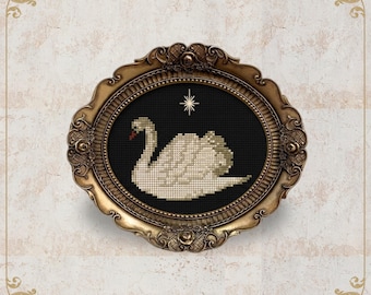 May include: A cross-stitch swan design in a gold oval frame. The swan is white with a red beak, set against a black background with a star. The frame has ornate detailing and the text "NobleLadyPupsik" is at the bottom.