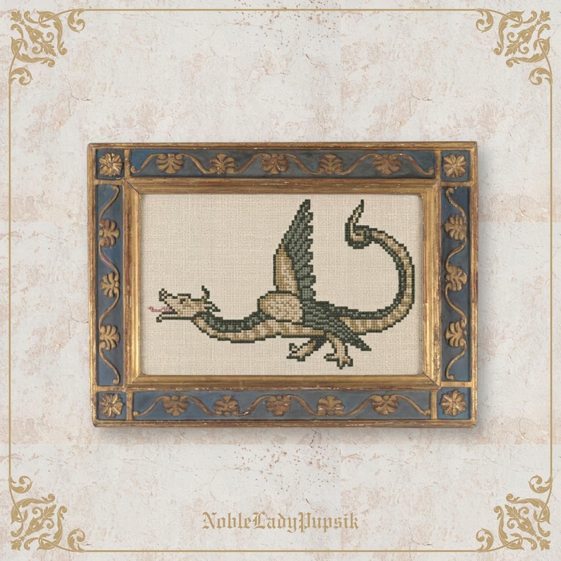 May include: Cross-stitch artwork of a dragon in a gold and blue frame. The dragon is green and tan with a long tail and outstretched wings. The frame has ornate gold detailing. The text "NobleLadyPupsik" is at the bottom.