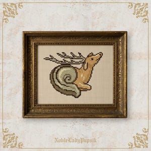 May include: Cross-stitch art in a gold frame. The artwork depicts a whimsical creature, a snail with deer antlers and body, in tan, brown, and green. The text "NobleLadyPupsik" is at the bottom.