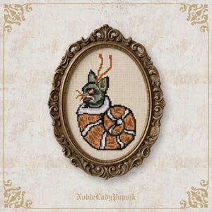 May include: Cross-stitch artwork featuring a green-faced creature with orange antlers and a striped shell-like body, set within an ornate, oval, gold-coloured frame. The text "NobleLadyPupsik" is at the bottom.