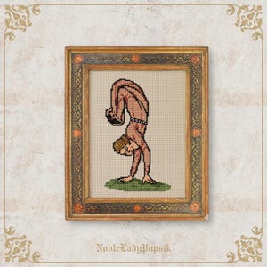 May include: Cross-stitch artwork in a gold ornate frame. The artwork depicts a person in a handstand, rendered in shades of brown and beige. The background is a light beige, and the frame has decorative detailing. The text "NobleLadyPupsik" is at the bottom.