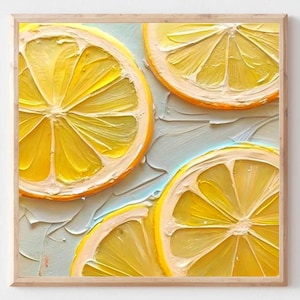 May include: A framed artwork featuring a close-up of four lemon slices. The lemons are bright yellow with white and orange edges, set against a textured, light blue and white background. The artwork is in a wooden frame.