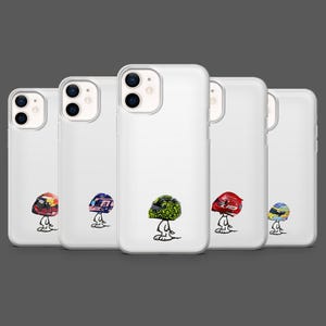 May include: White phone cases with cartoon helmet designs in various colours. Each case displays a different helmet design, including red, blue, green, and yellow. The cases are arranged in a row, showcasing the range of designs.