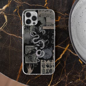 May include: Clear phone case with a collage design featuring a white snake, botanical illustrations, sheet music, and the word "Butterfly". The case has a black and white color scheme.