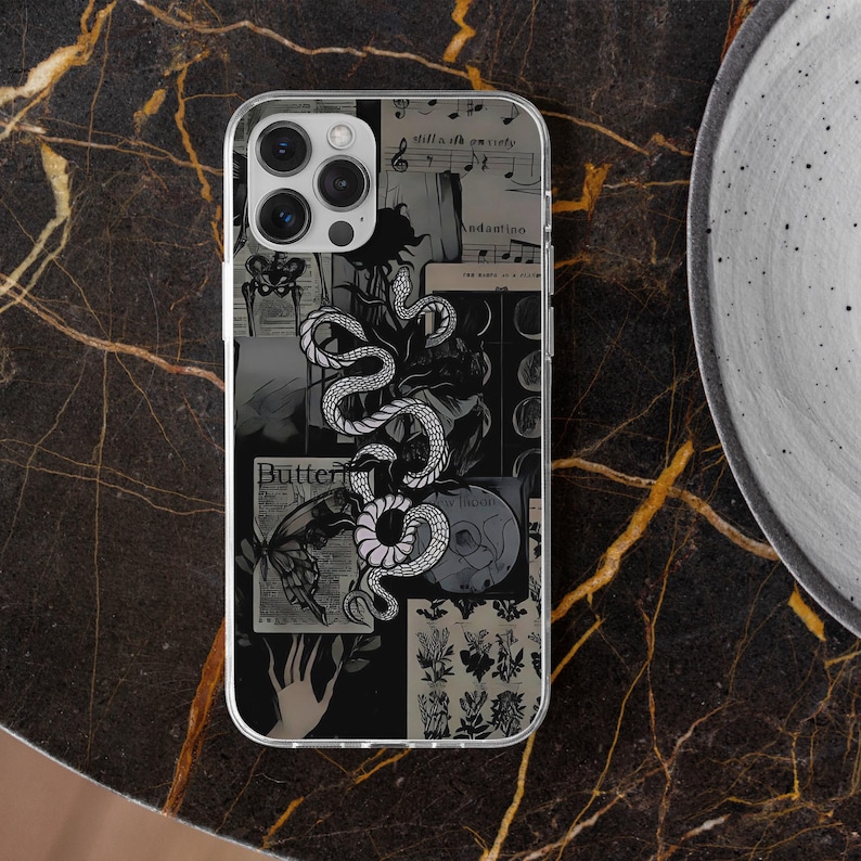 May include: Clear phone case with a collage design featuring a white snake, botanical illustrations, sheet music, and the word "Butterfly". The case has a black and white color scheme.