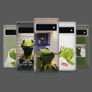 May include: A collection of phone cases featuring Kermit the Frog in various poses. The cases display images of Kermit in a mugshot, smoking, and wearing a Supreme logo. The cases are in a variety of colors, including green and white.