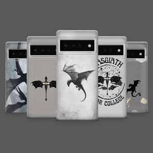 May include: A collection of phone cases featuring dragon designs. The cases display various dragon illustrations in black and white, including a flying dragon, a dragon with a cross, and a dragon with the text "ASGIATH OR COLLEGE". The cases are displayed against a gray background.