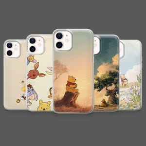 May include: Five iPhone cases featuring Winnie the Pooh and friends. The cases display illustrations of Pooh Bear, Eeyore, Piglet, and other characters in various scenes. The cases have a clear, protective design.