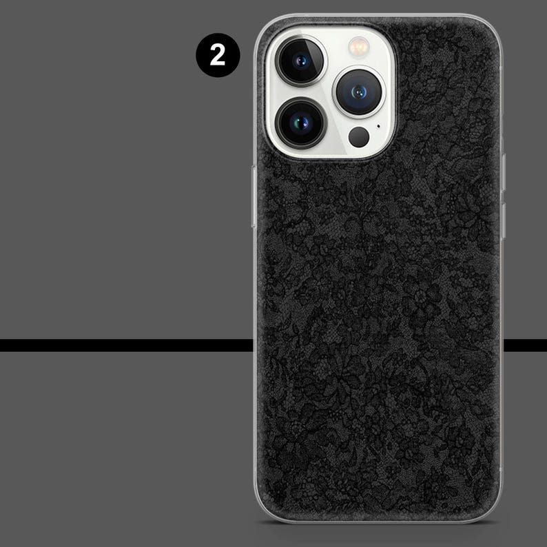 May include: A black phone case with a floral lace pattern. The case has a clear border and a camera cutout. The phone case is designed to fit a smartphone.