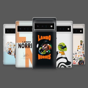 May include: A collection of five phone cases with various designs. One case features the name "LANDO NORRIS" with an orange stripe. Another displays a portrait of a person in a racing helmet. Other cases have cartoon graphics.