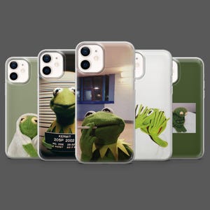 May include: A collection of five phone cases featuring Kermit the Frog in various poses. The cases display images of Kermit in different scenarios, including a mugshot and smoking a cigarette. The cases are in clear, green, and white.