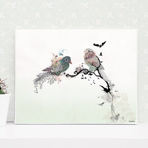 A whimsical art print featuring two stylized birds perched on a branch with intricate details. The birds are a mix of blue, green, and brown, and the branch is adorned with black and white swirls. The background is a light green with a subtle pattern.