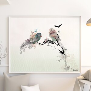 A framed print of two birds perched on a branch with a floral design. The birds are a light blue and a pink color. The background is a light green with a subtle pattern.