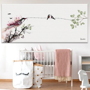 watercolor painting of a pink bird perched on a branch with green leaves. Two smaller birds are perched on a branch above the larger bird. The painting is on a white background.