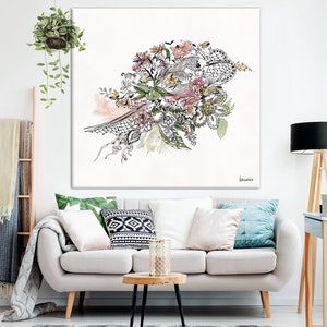 May include: A white canvas print with a black and white illustration of a floral bouquet with pink, green, and yellow accents. The bouquet is in the shape of a bird with its wings spread out.