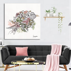 May include: A black sofa with a pink throw blanket and a gold coffee table in a living room setting. A framed black and white floral illustration hangs on the wall above the sofa.